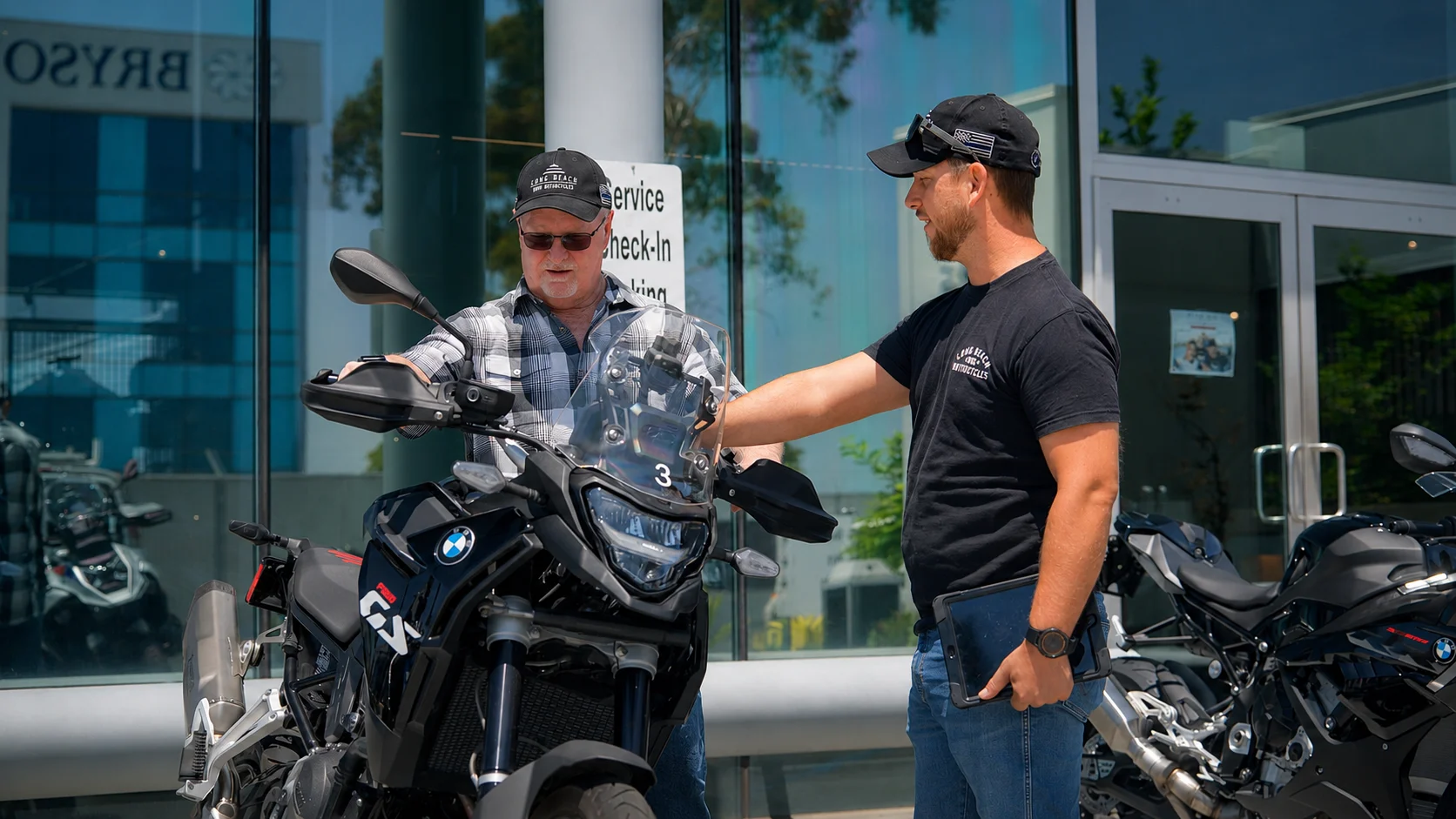 man getting assisted on buying a motorcycle